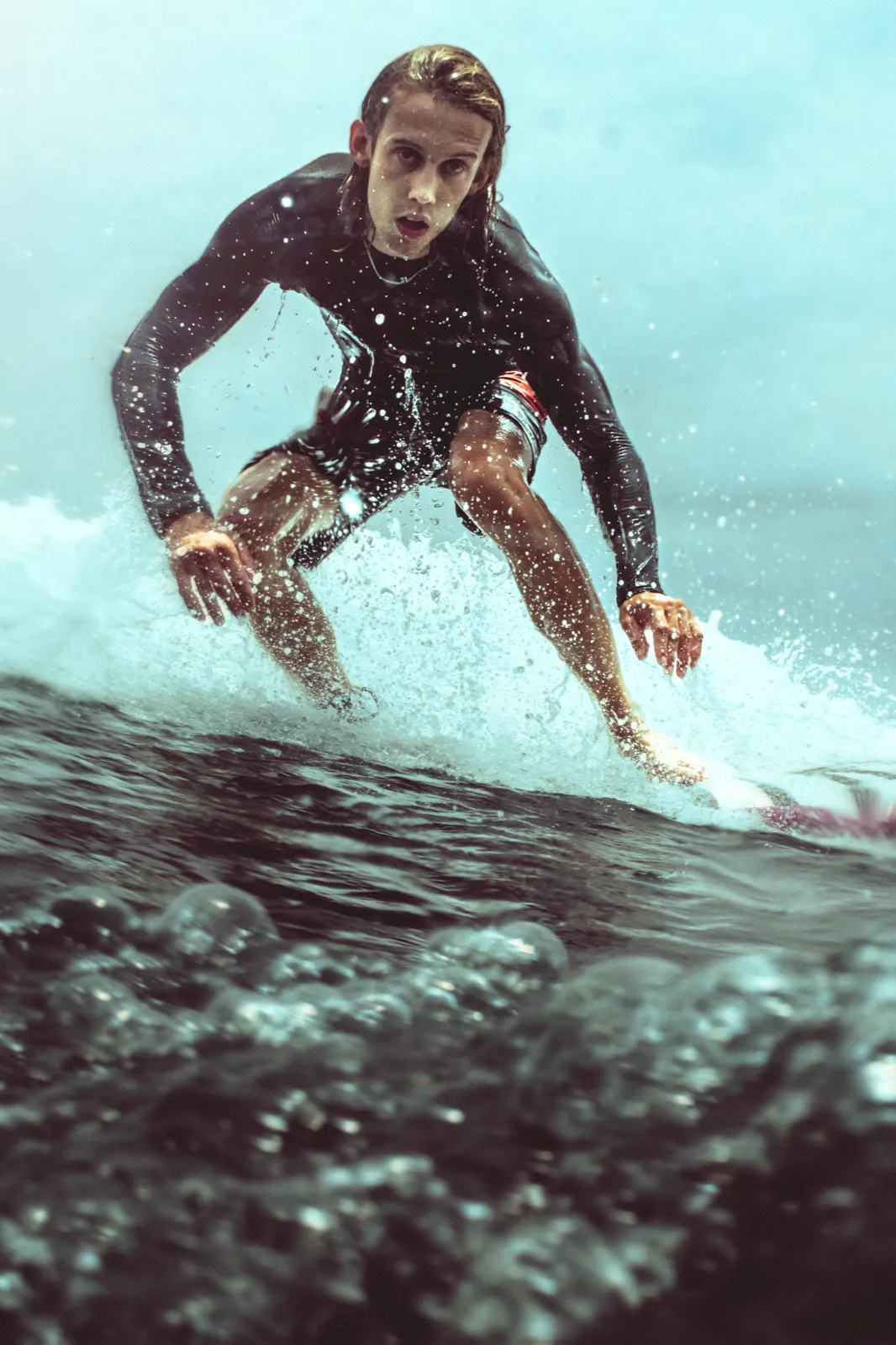 A surfer riding a reef break near Gili Air